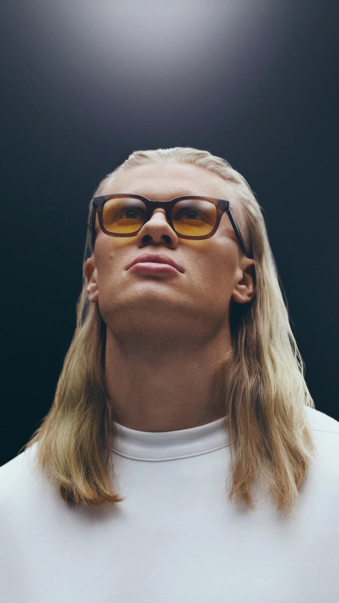 Athlete wearing amber glasses under arena lights