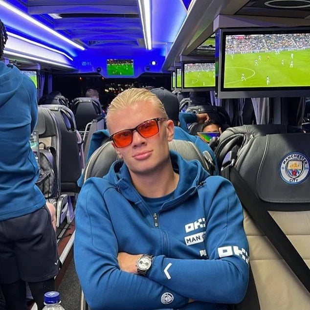 Athlete wearing orange glasses while travelling with his team